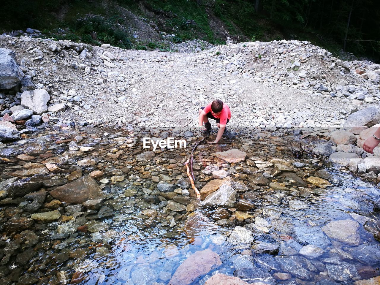 High angle view of boy by stream