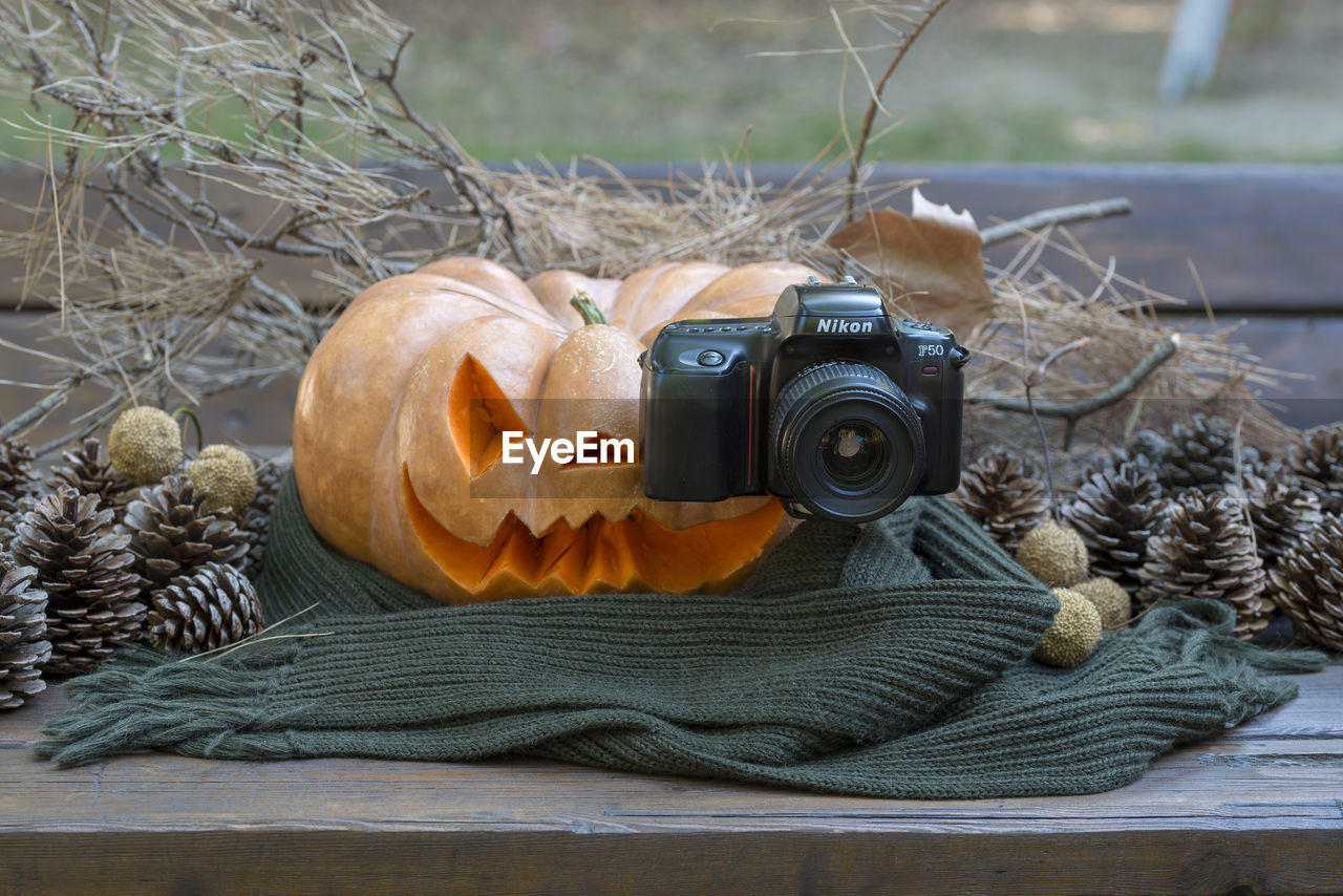 CLOSE-UP OF CAMERA ON BARBECUE GRILL WITH FIRE