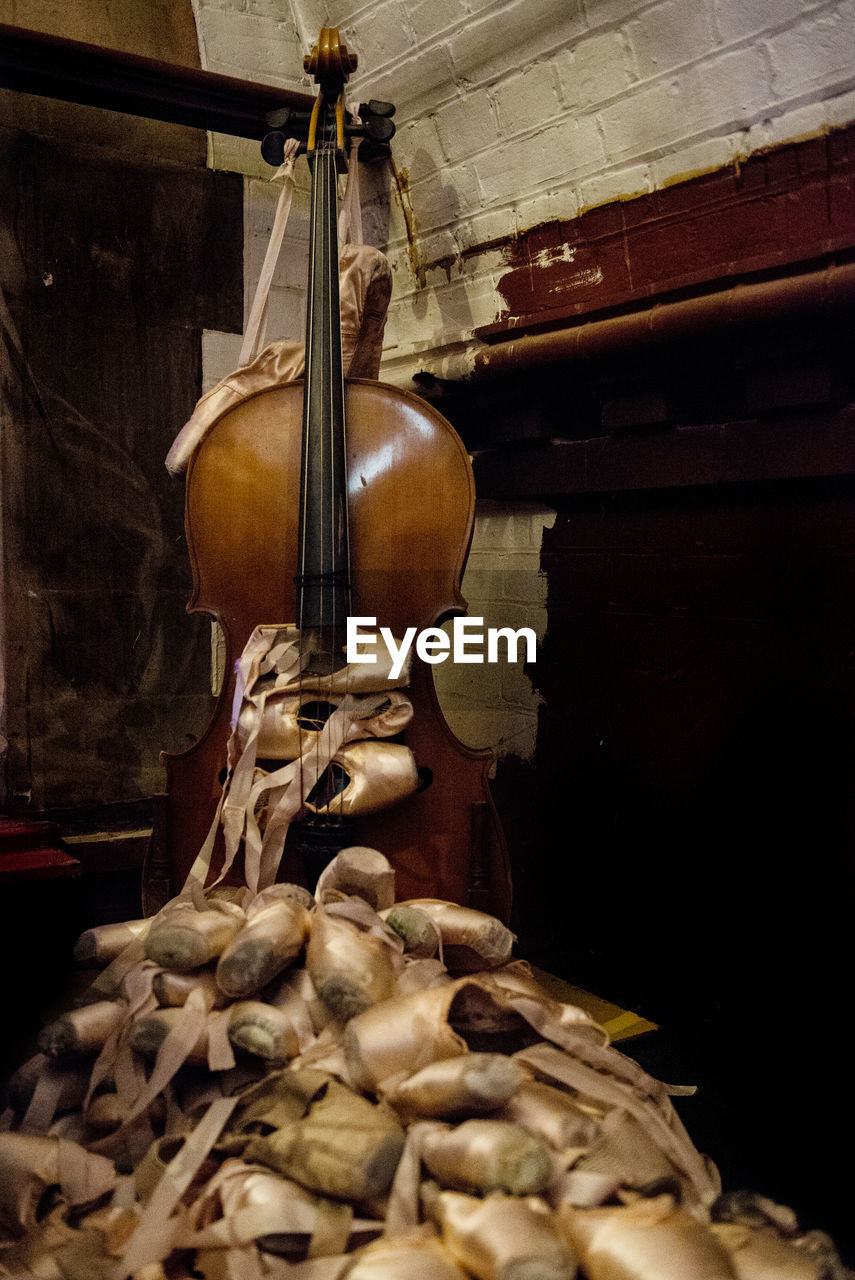 Abandoned ballet shoes and double bass at home