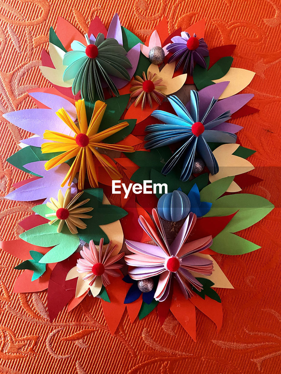 flower, petal, leaf, art, no people, multi colored, wheel, creativity, red, pattern, origami paper, high angle view, plant, craft, flowering plant, indoors, close-up, origami, art paper, still life, directly above, nature, paper, decoration, beauty in nature