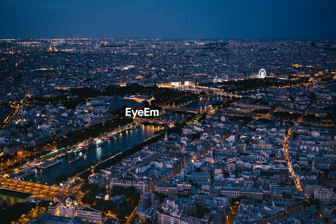 High angle view of illuminated city buildings at night