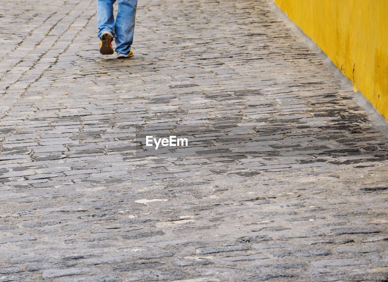 LOW SECTION OF MAN WALKING ON FLOOR
