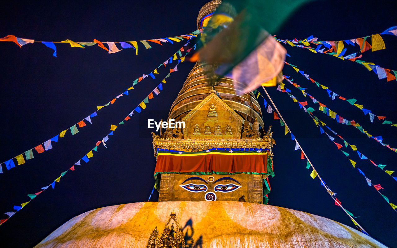 religion, belief, temple - building, architecture, spirituality, decoration, flag, tradition, travel destinations, nature, sky, built structure, multi colored, history, no people, event, travel, place of worship, celebration, building, night, the past, outdoors, environment, pagoda, landscape