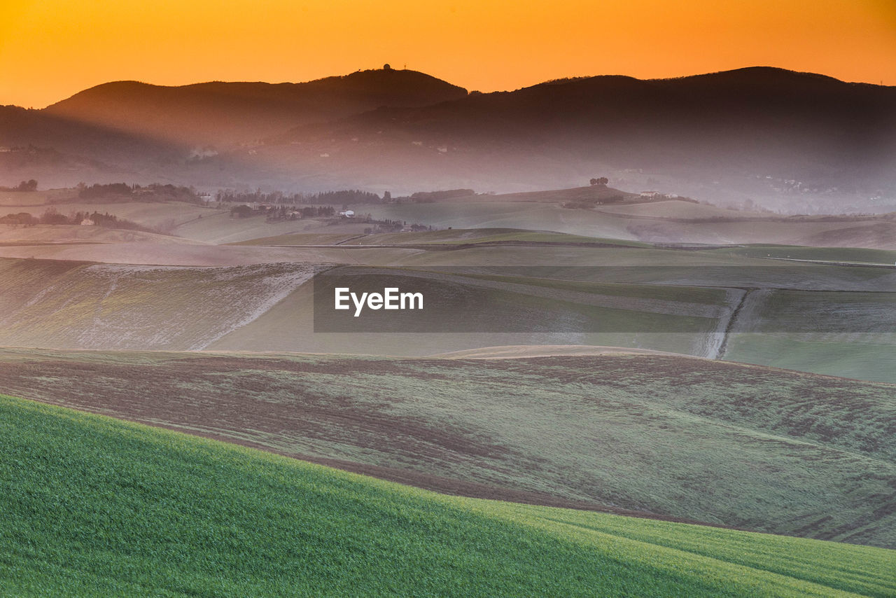 Scenic view of field against sky during sunset