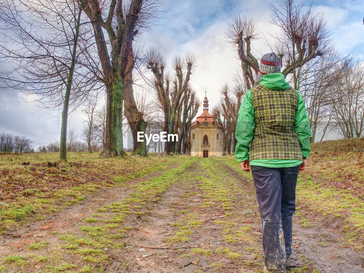 Rear view of woman in deerstalker vest and warm cap looking at end of rees avenue