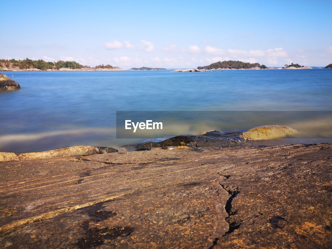 SCENIC VIEW OF ROCKS ON BEACH AGAINST SKY