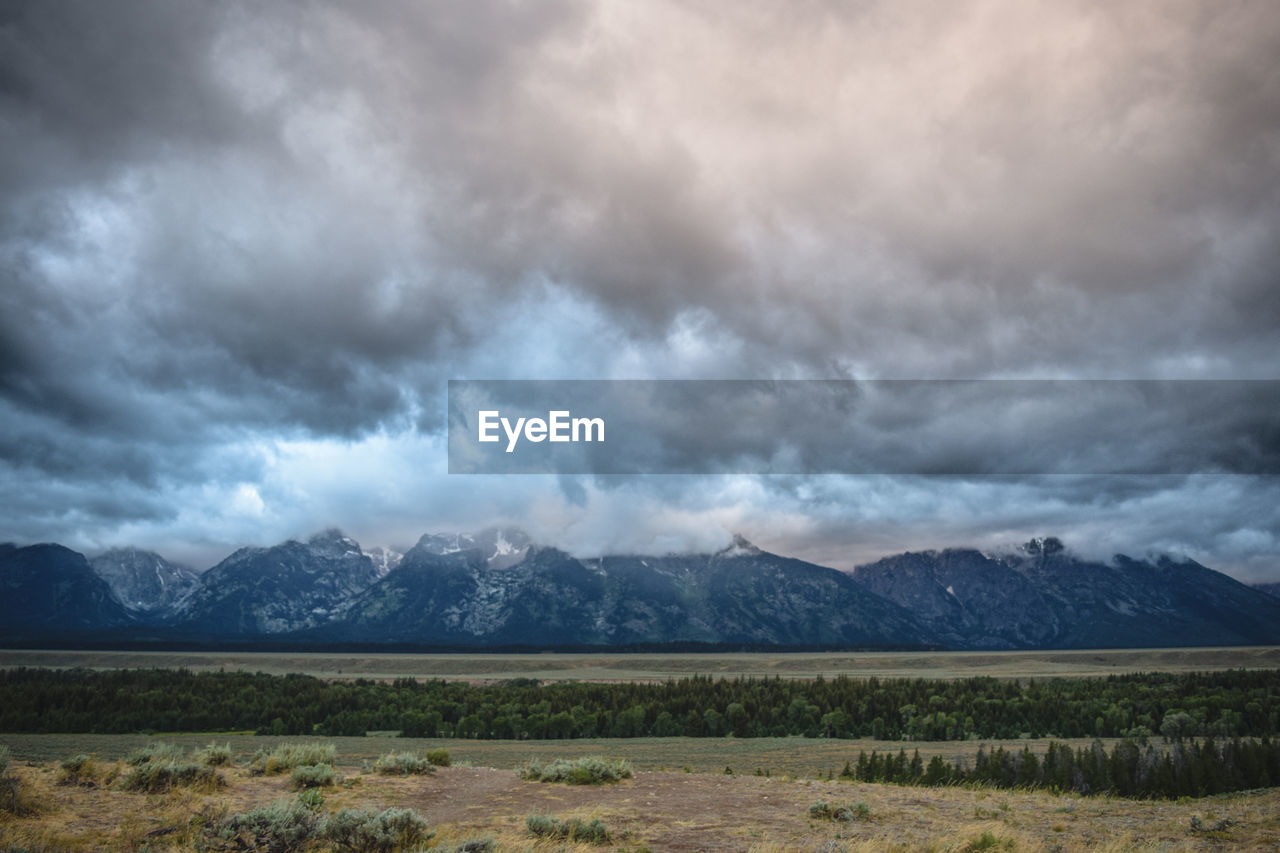 Scenic view of mountains against cloudy sky