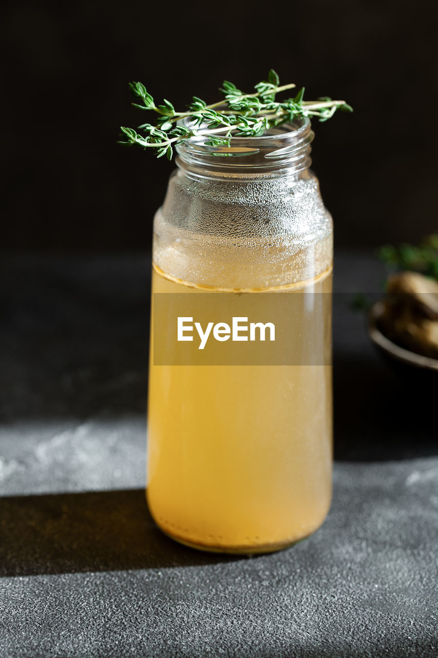 Ingredients for cooking bone broth. stock pot with veggies, herbs, and beef. vertical orientation