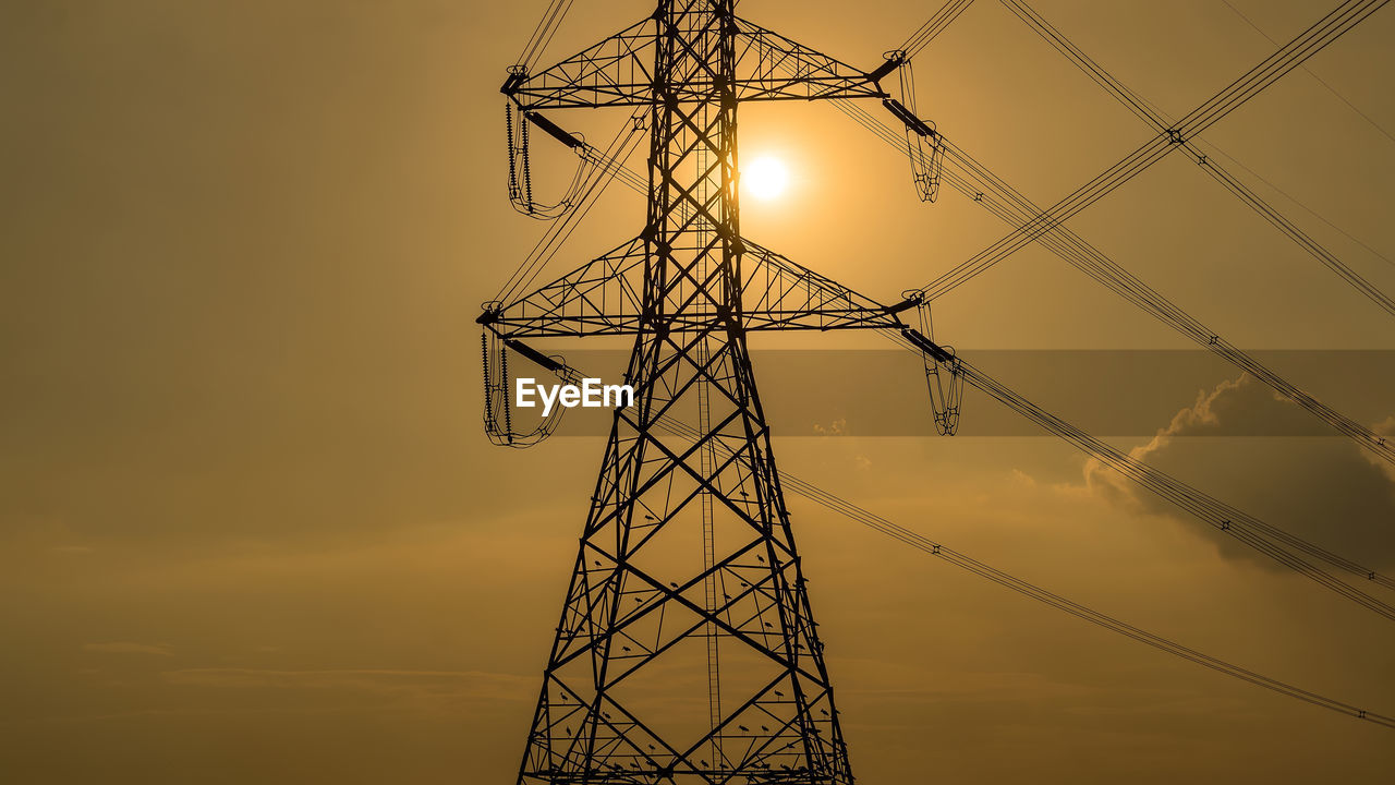 technology, power generation, electricity, power supply, sky, electricity pylon, sunset, transmission tower, cable, silhouette, tower, overhead power line, built structure, architecture, line, nature, no people, industry, environment, metal, electrical supply, power line, alloy, steel, high voltage sign, cloud, grid, outdoors, communication, electrical grid, yellow, outdoor structure, public utility, business finance and industry, mast, environmental conservation