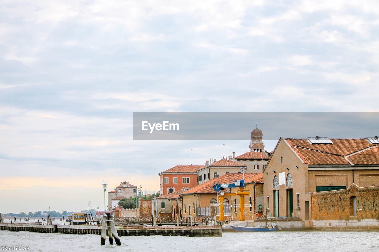 View of venice waterfront against cloudy sky