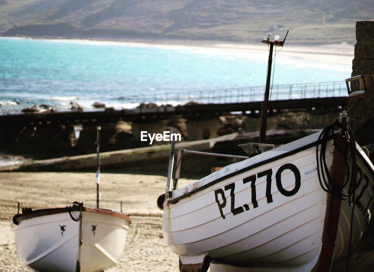 Close-up of text on beach against sky