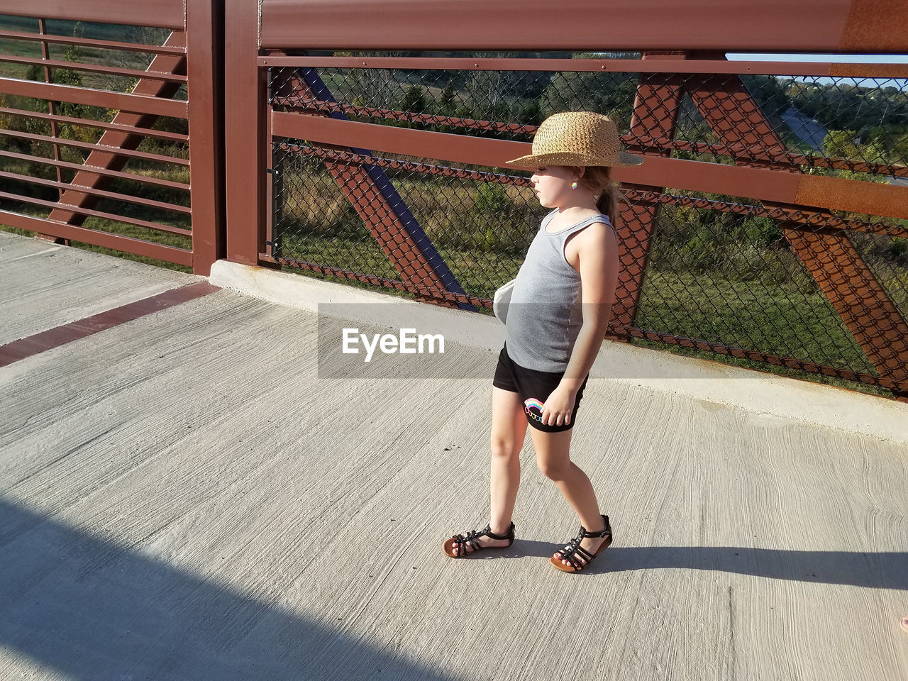 Cute girl walking on footbridge 