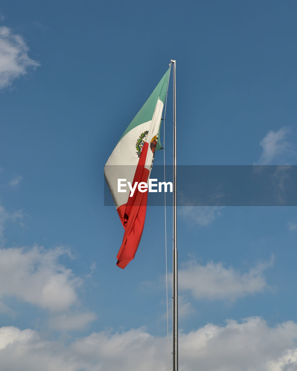 Low angle view of flag against sky