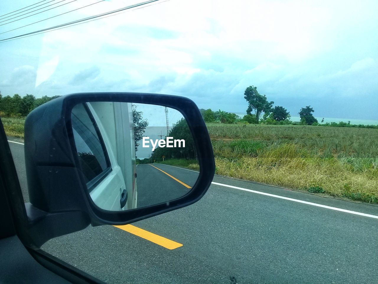 REFLECTION ON SIDE-VIEW MIRROR OF CAR