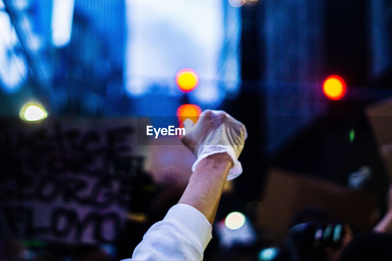 Midsection of person holding illuminated city at night