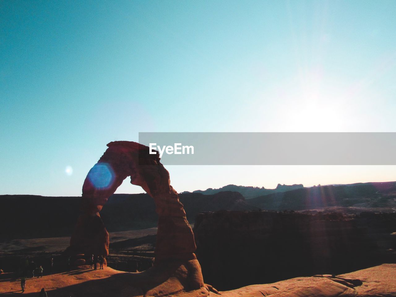 PERSON ON ROCK AGAINST SKY