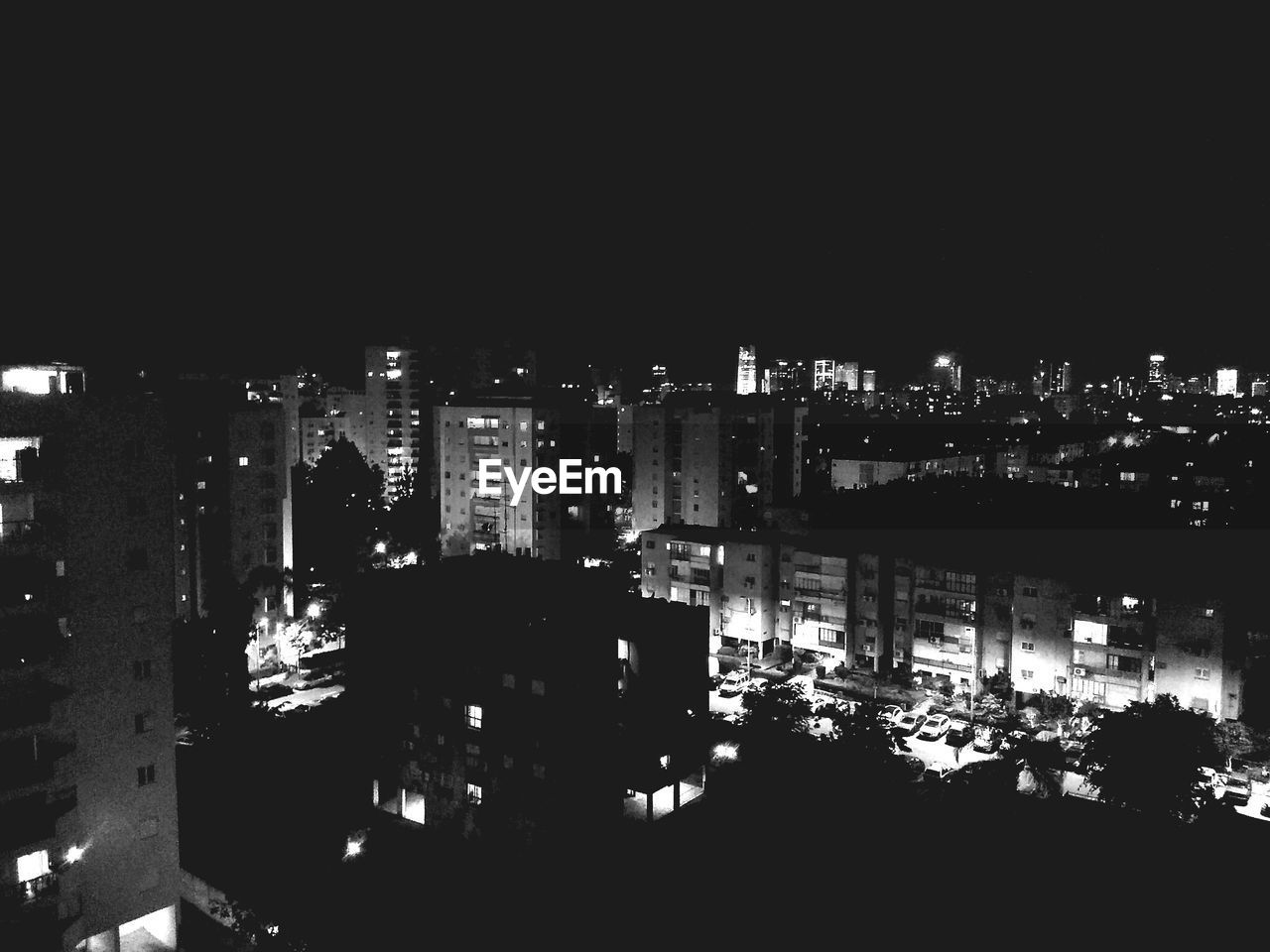 HIGH ANGLE VIEW OF ILLUMINATED BUILDINGS AGAINST SKY