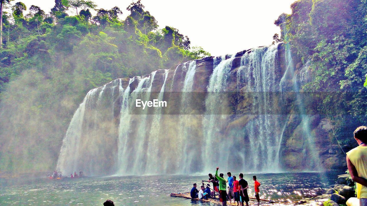 PANORAMIC VIEW OF PEOPLE AT WATERFALL