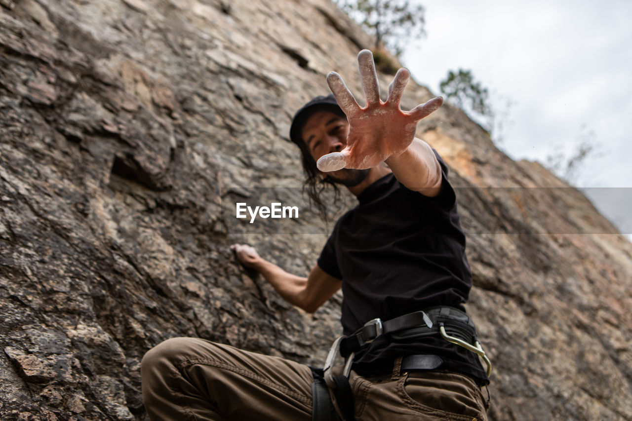 Low angle view of man on rock