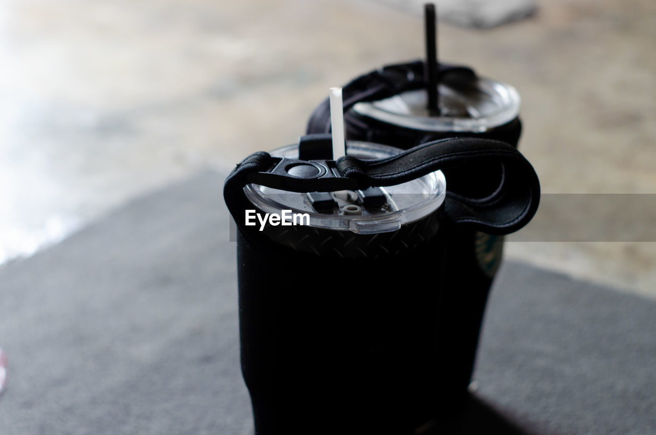 High angle view of black coffee cup on land