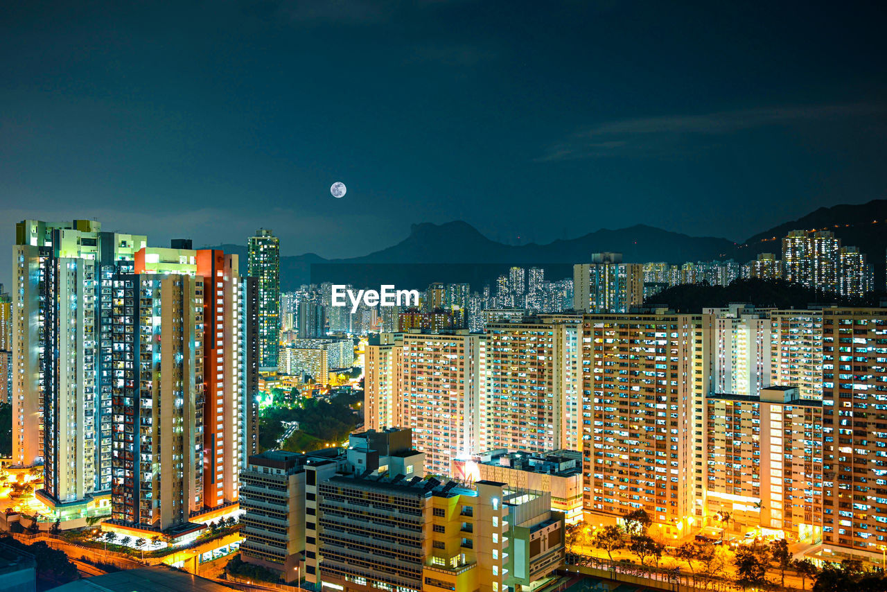 High angle view of illuminated buildings in city at night