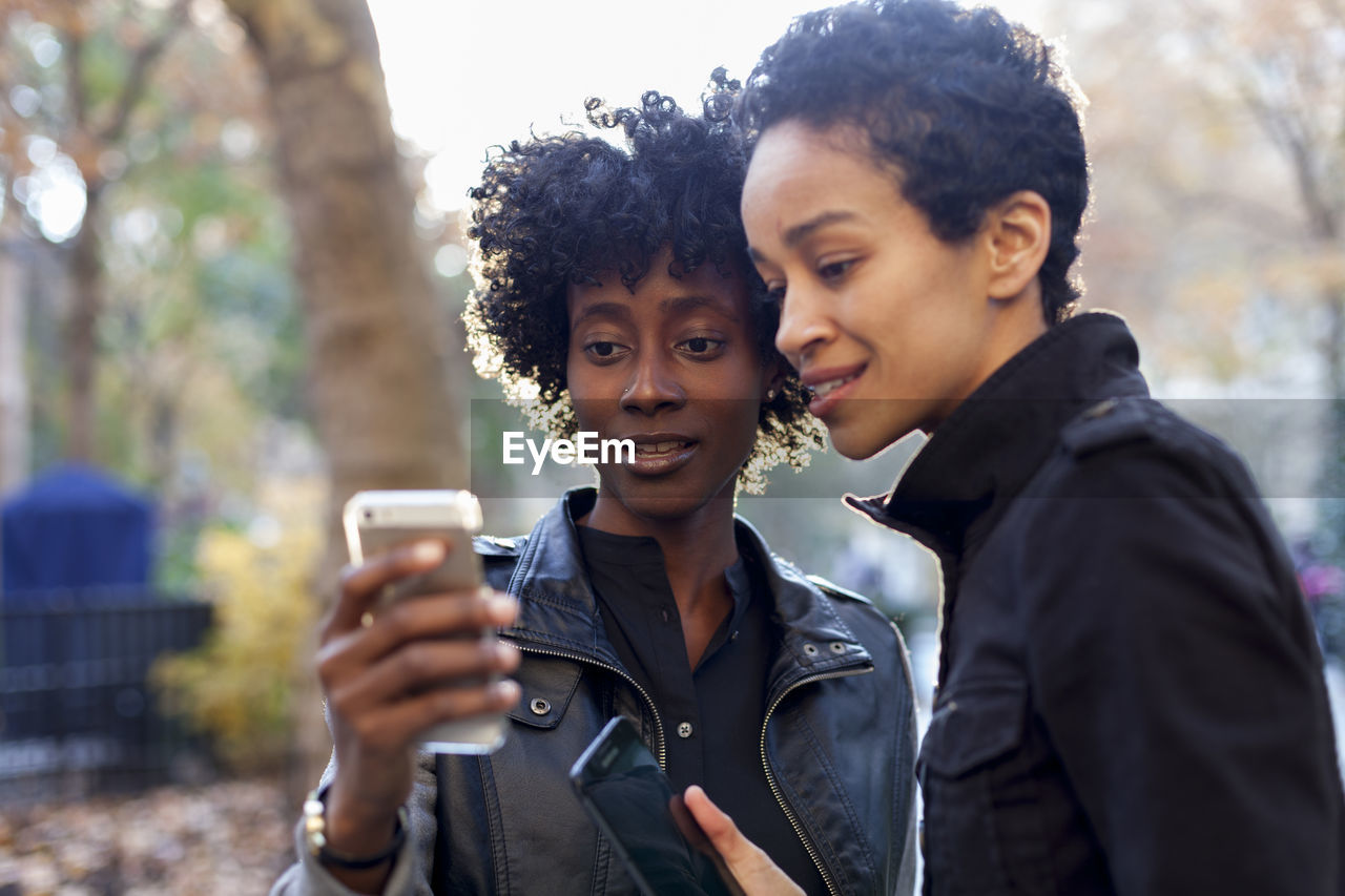 Young women checking their smart phones