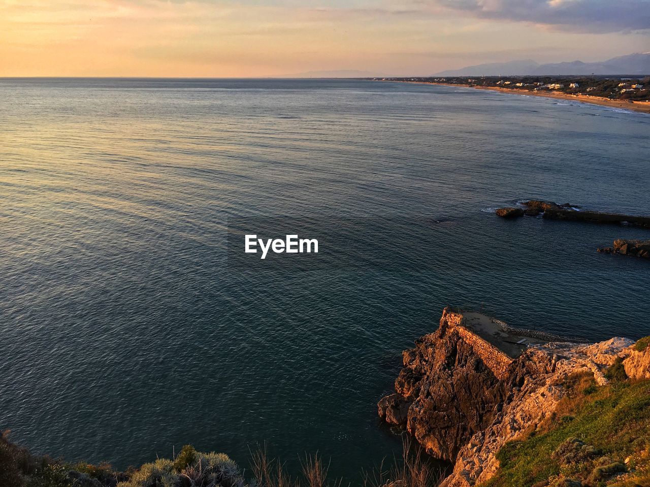 Scenic view of sea against sky at sunset