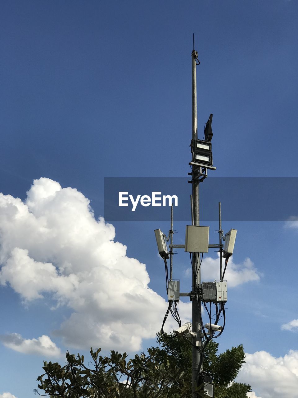 Low angle view of repeater tower against blue sky