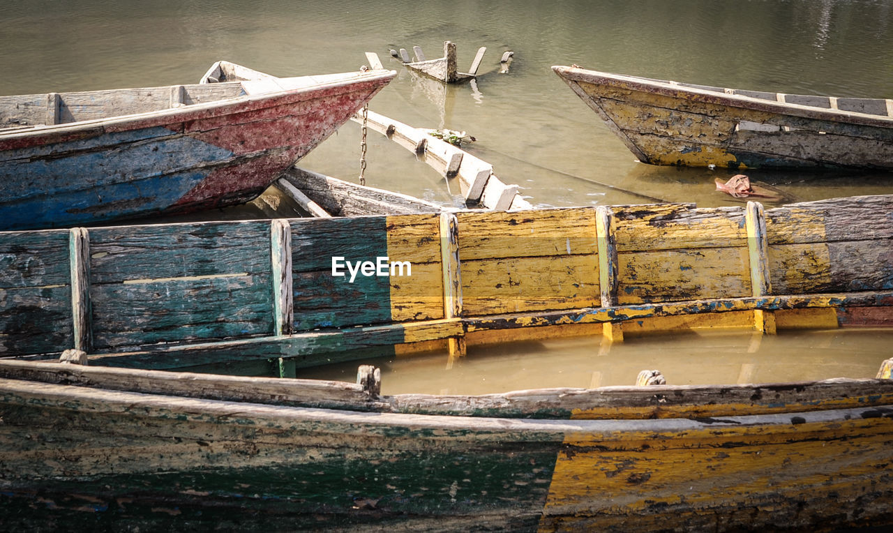 Old wooden boats moored in river