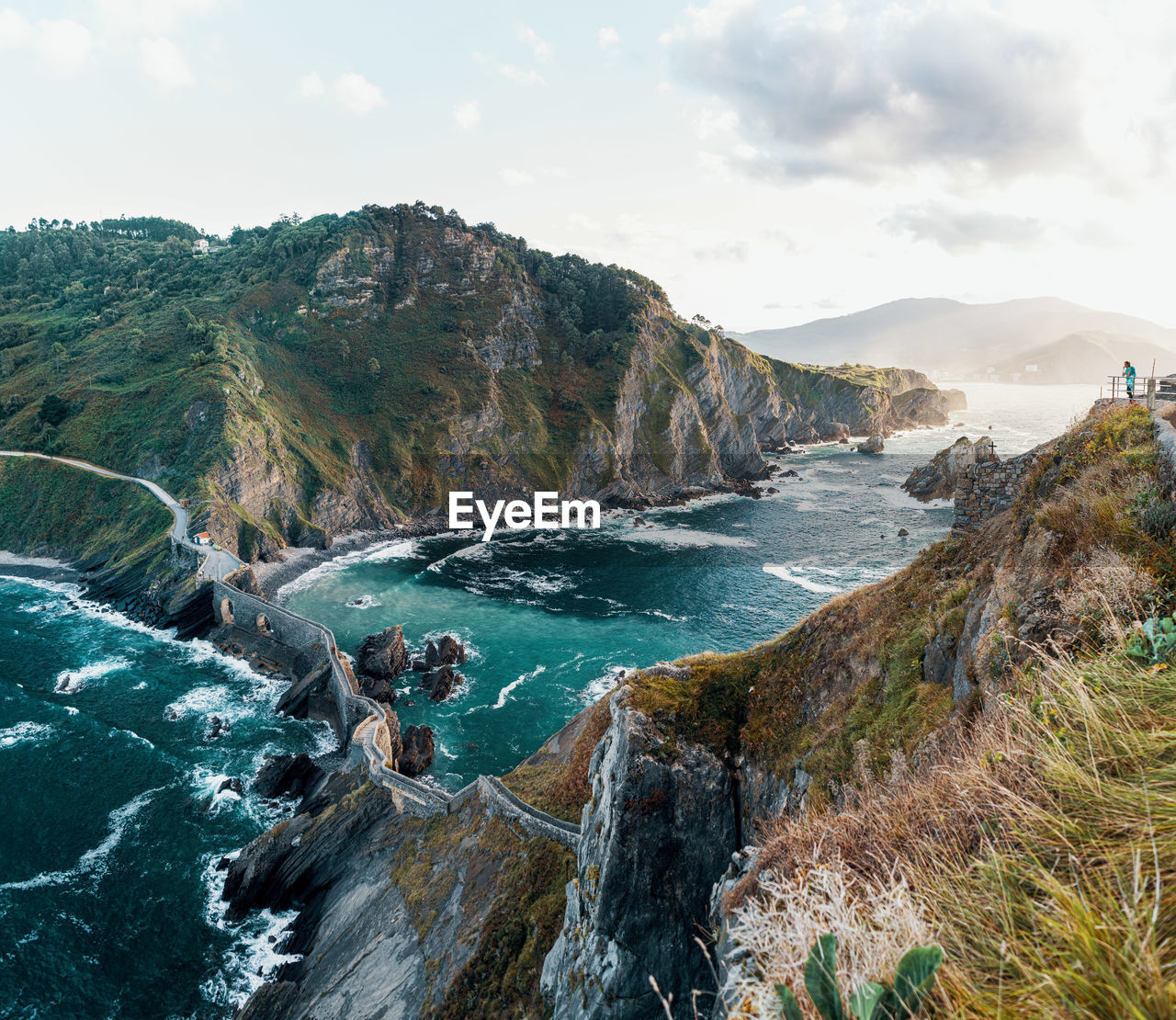 Panoramic view of sea and mountains against sky