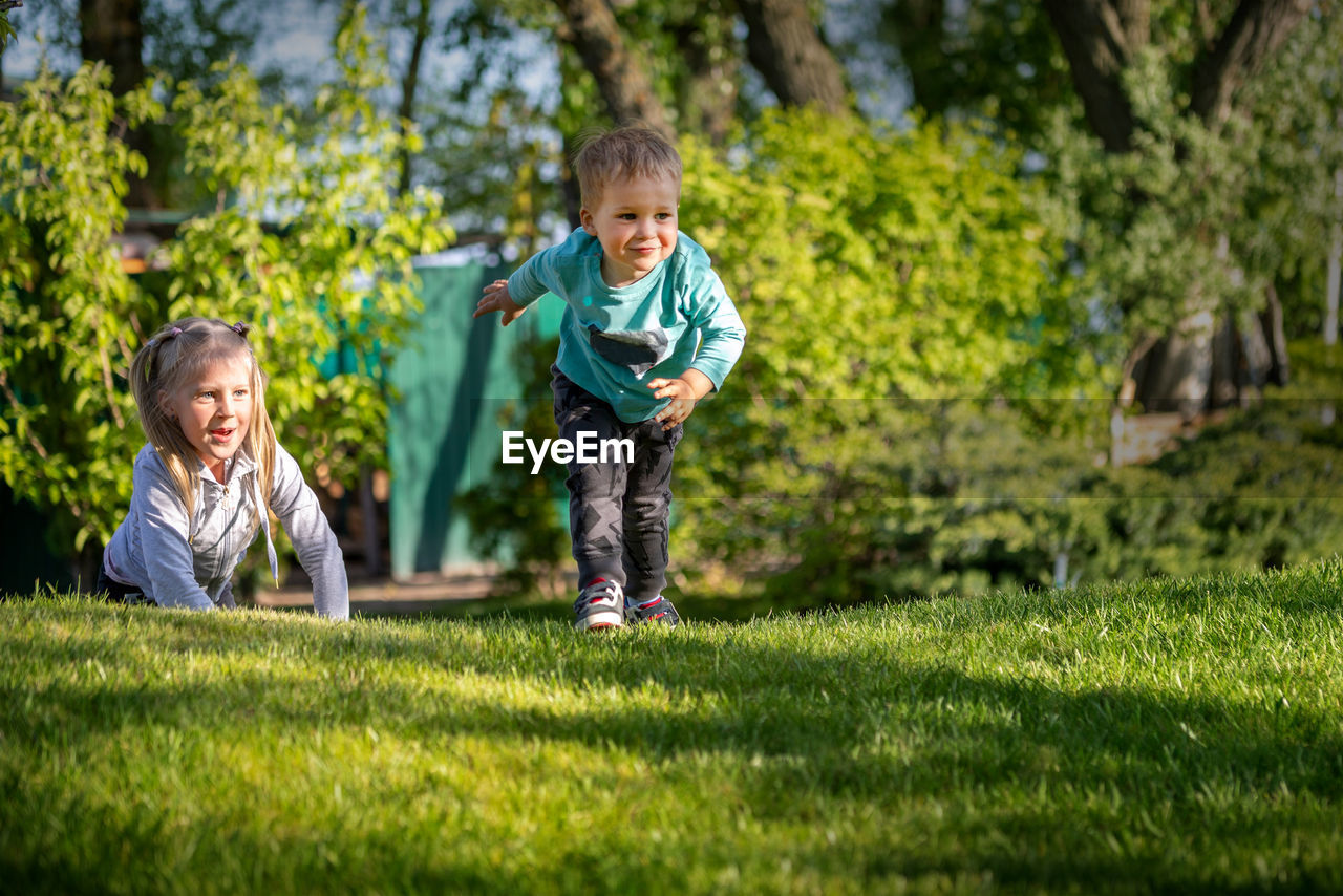 Happy sblings playing on grass