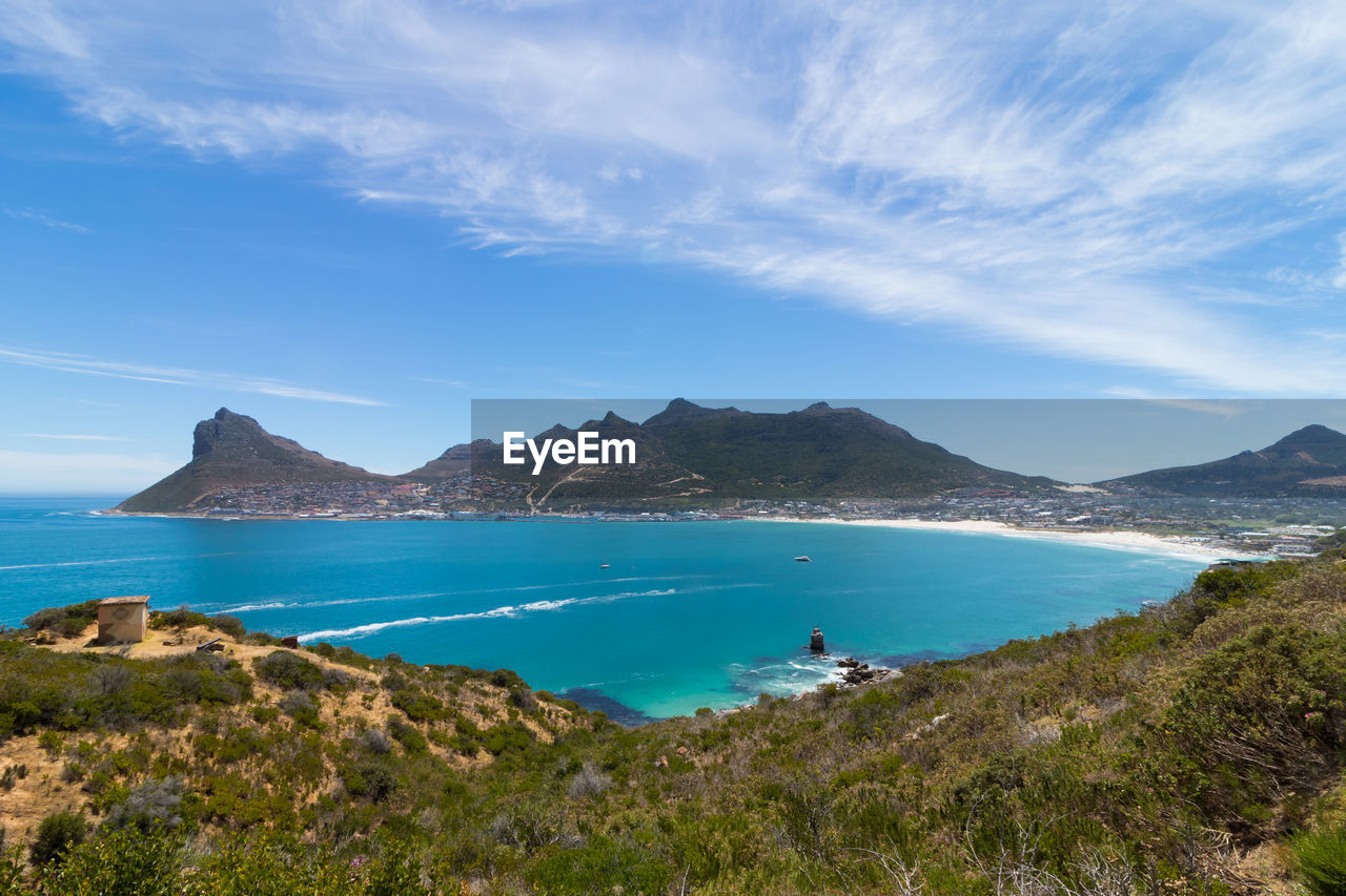 SCENIC VIEW OF BAY AGAINST BLUE SKY