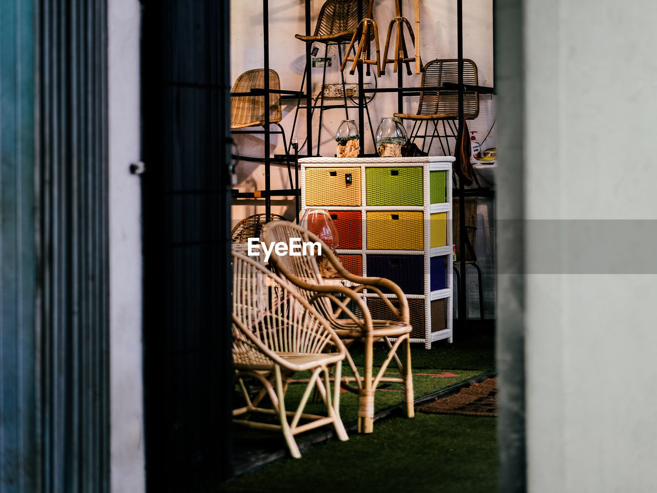 Rattan furniture on display on a high street shop front