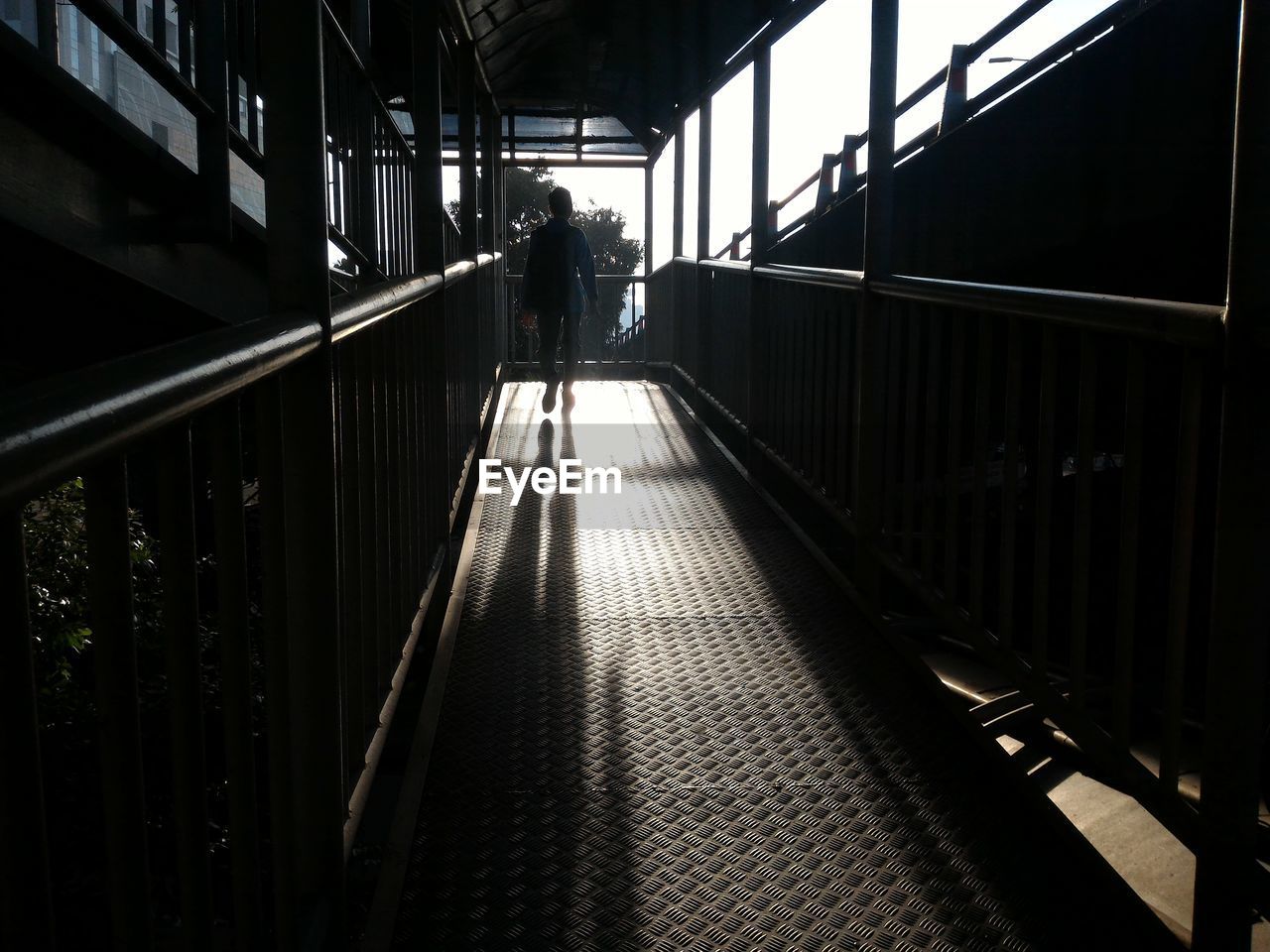 Man walking on illuminated railroad station platform