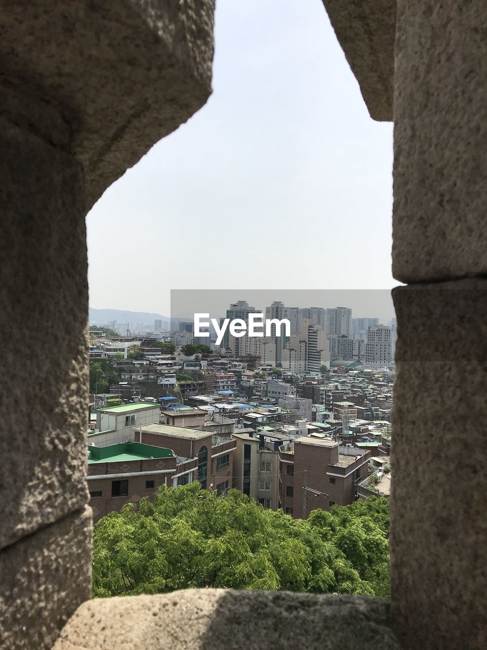 Skyscraper of seoul through the wall of the castle of old seoul.