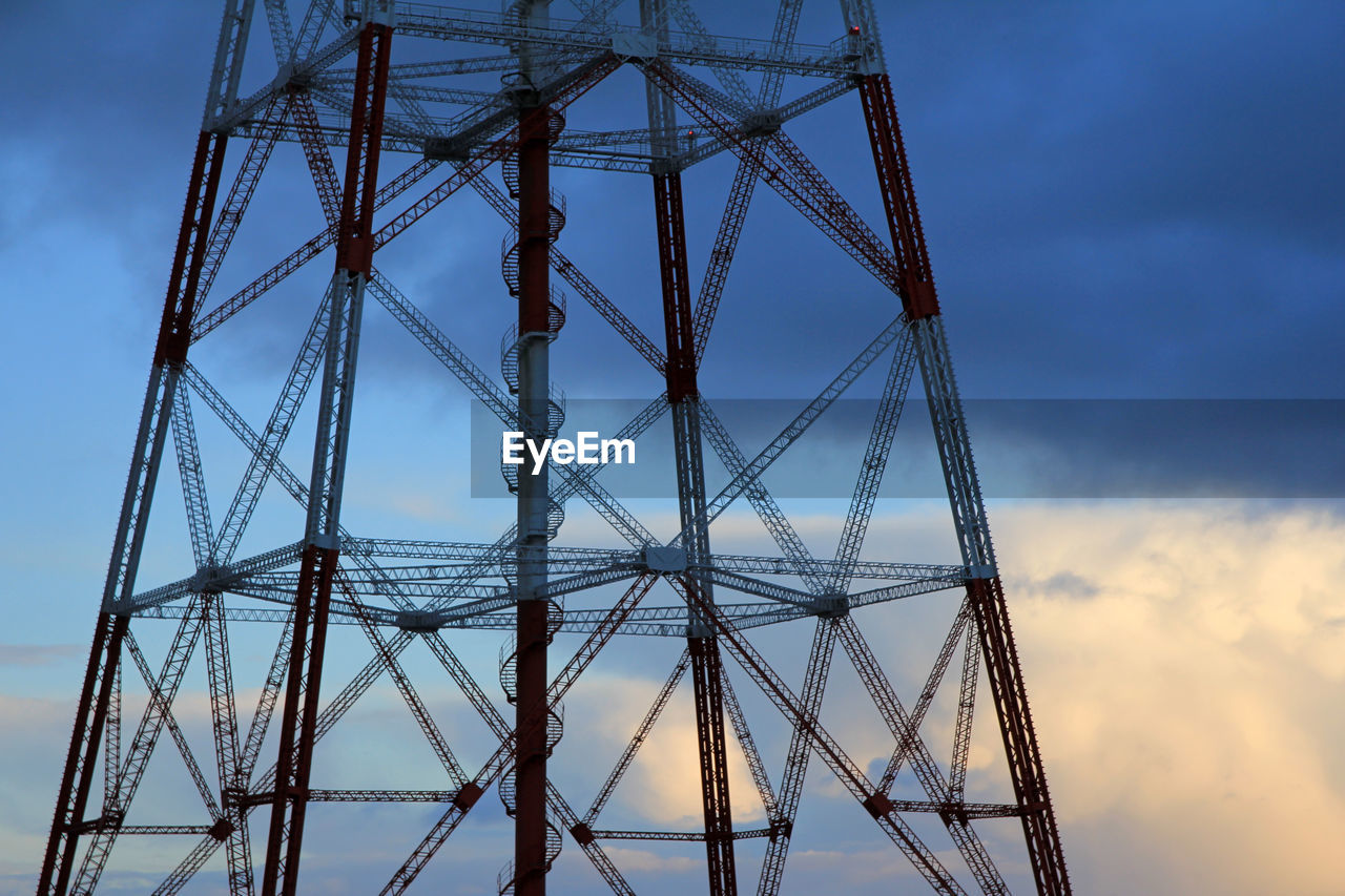 Low angle view of electricity pylon against sky