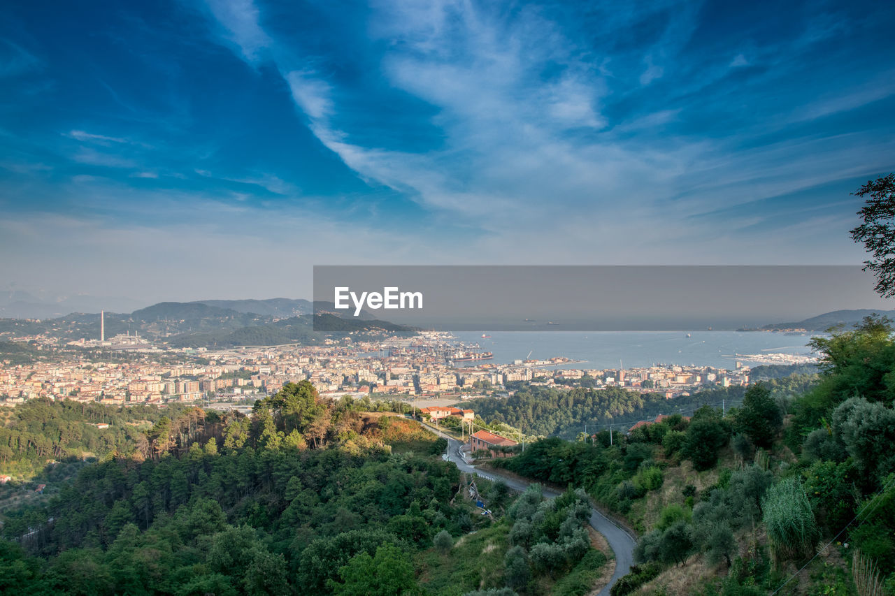 High angle view of cityscape against cloudy sky