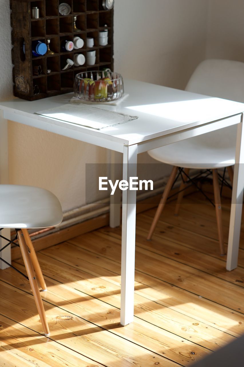 Close-up of chairs and table at home