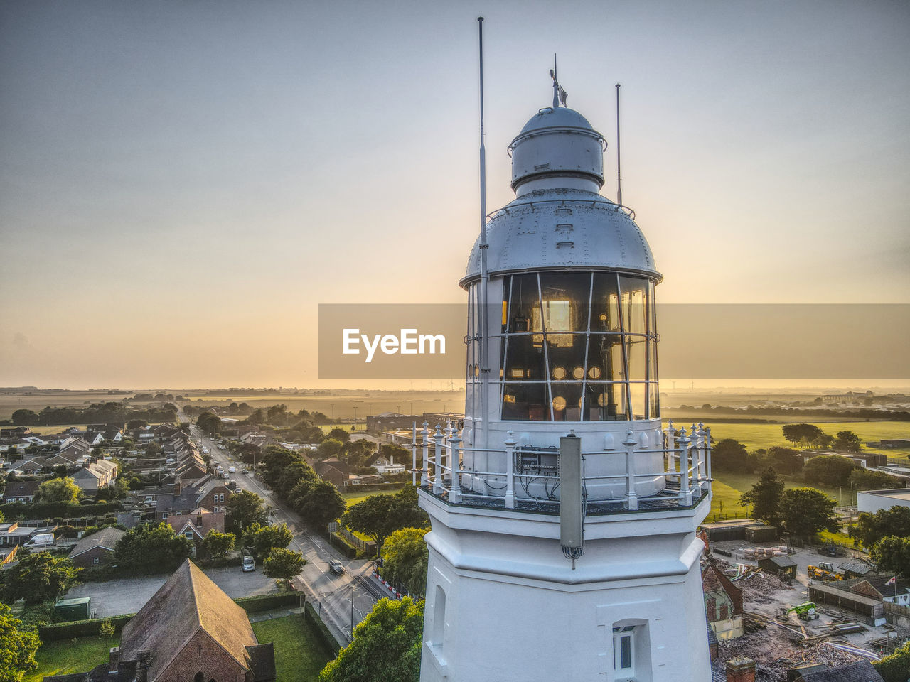 A drone view through the top of withernsea lighthouse at sunset