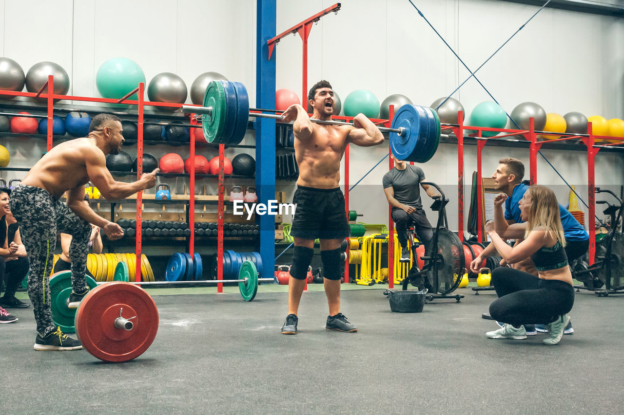 Man celebrating he is the champion of a weightlifting tournament