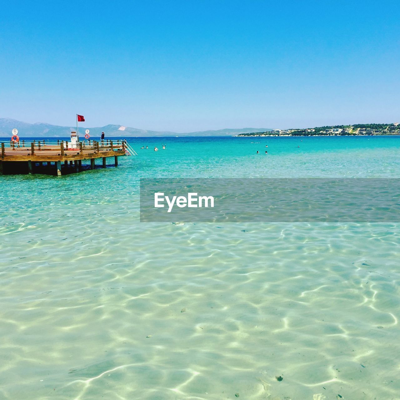 Scenic view of sea against clear blue sky