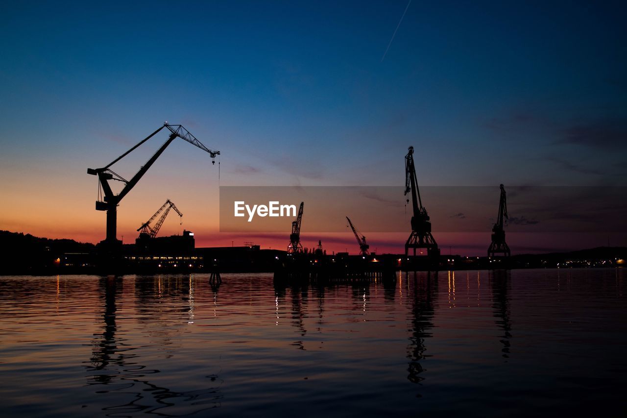 SILHOUETTE OF CRANES AT SUNSET