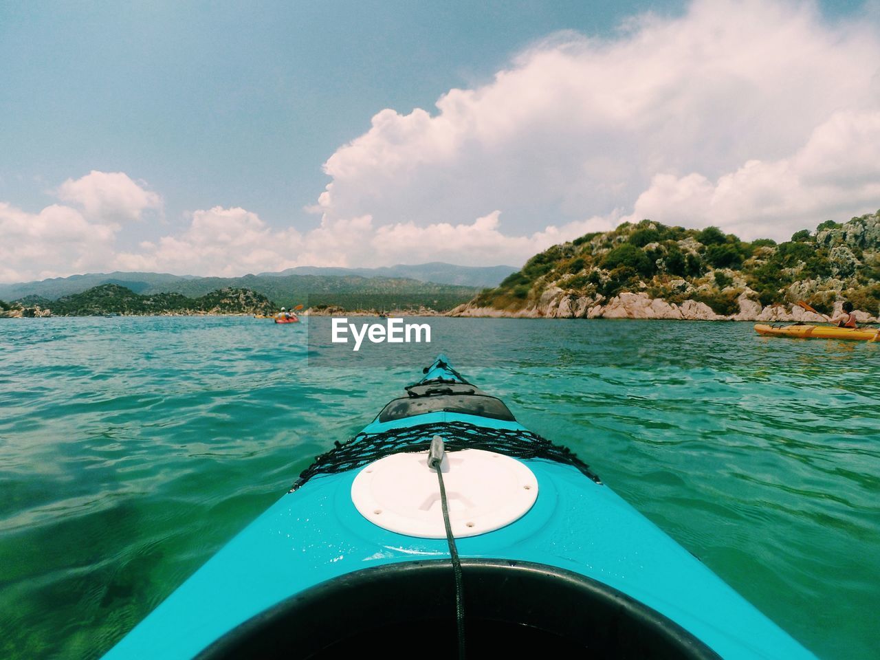 Boat in sea against cloudy sky