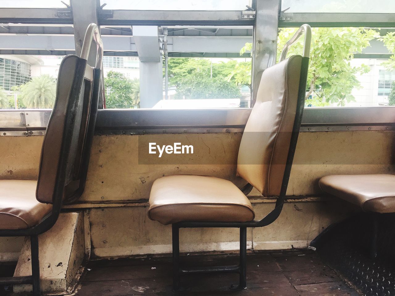 EMPTY CHAIRS AND TRAIN IN WINDOW