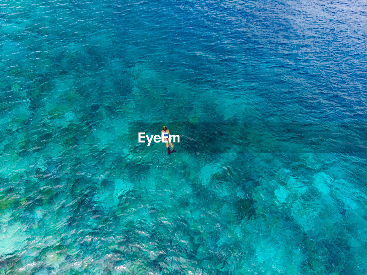 Aerial view of woman swimming in sea