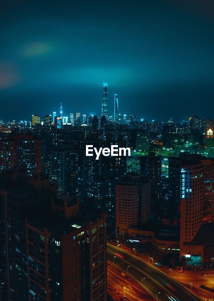 High angle view of illuminated buildings in city at night