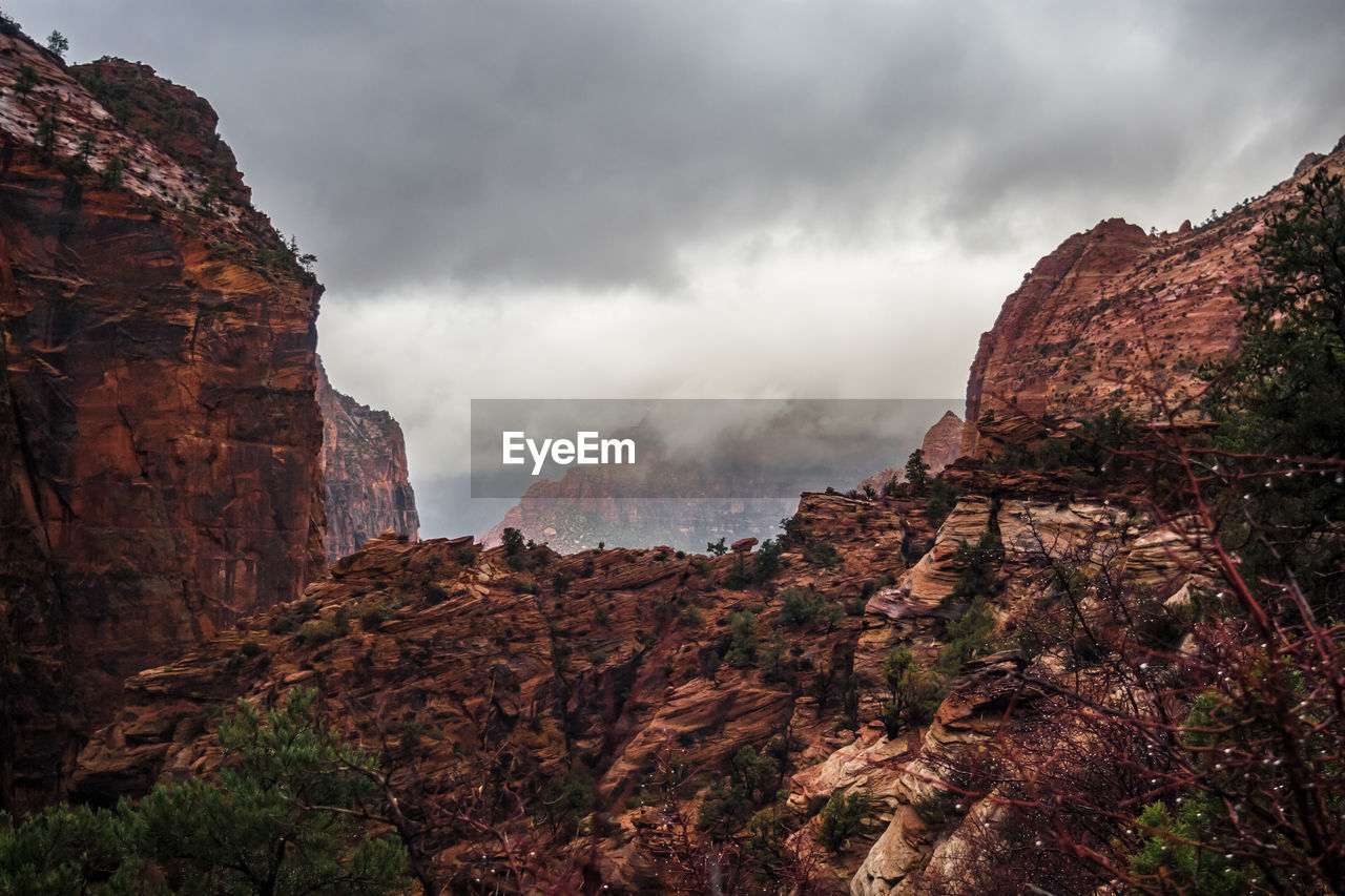 Scenic view of mountains against cloudy sky