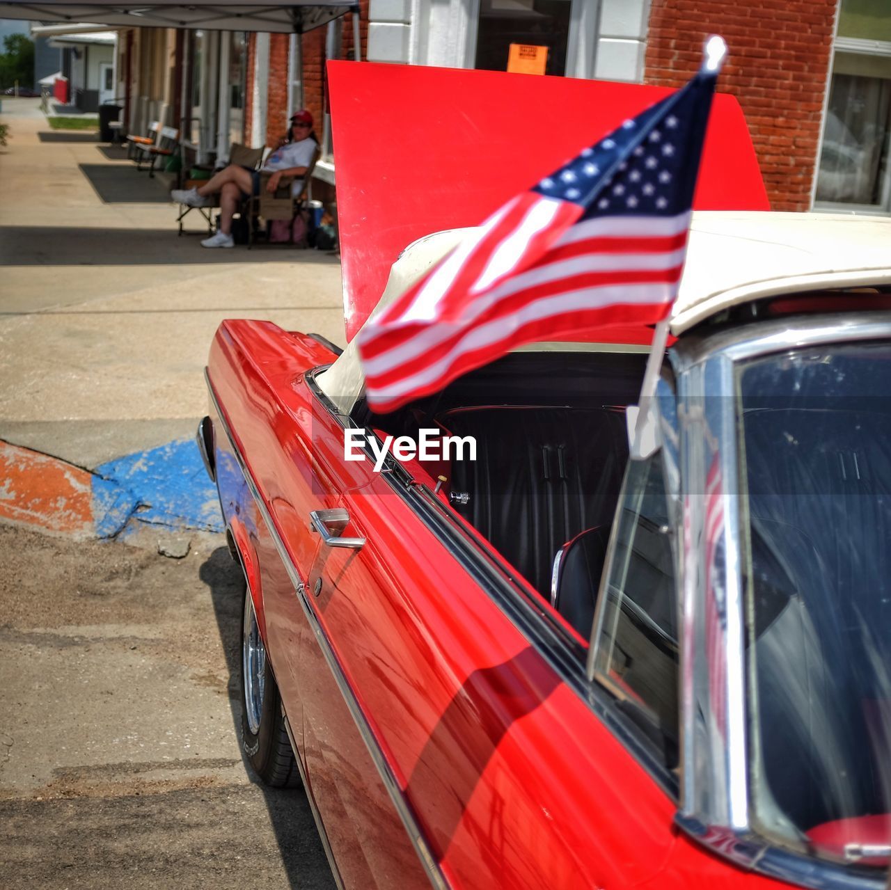 Close-up of american flag on red car