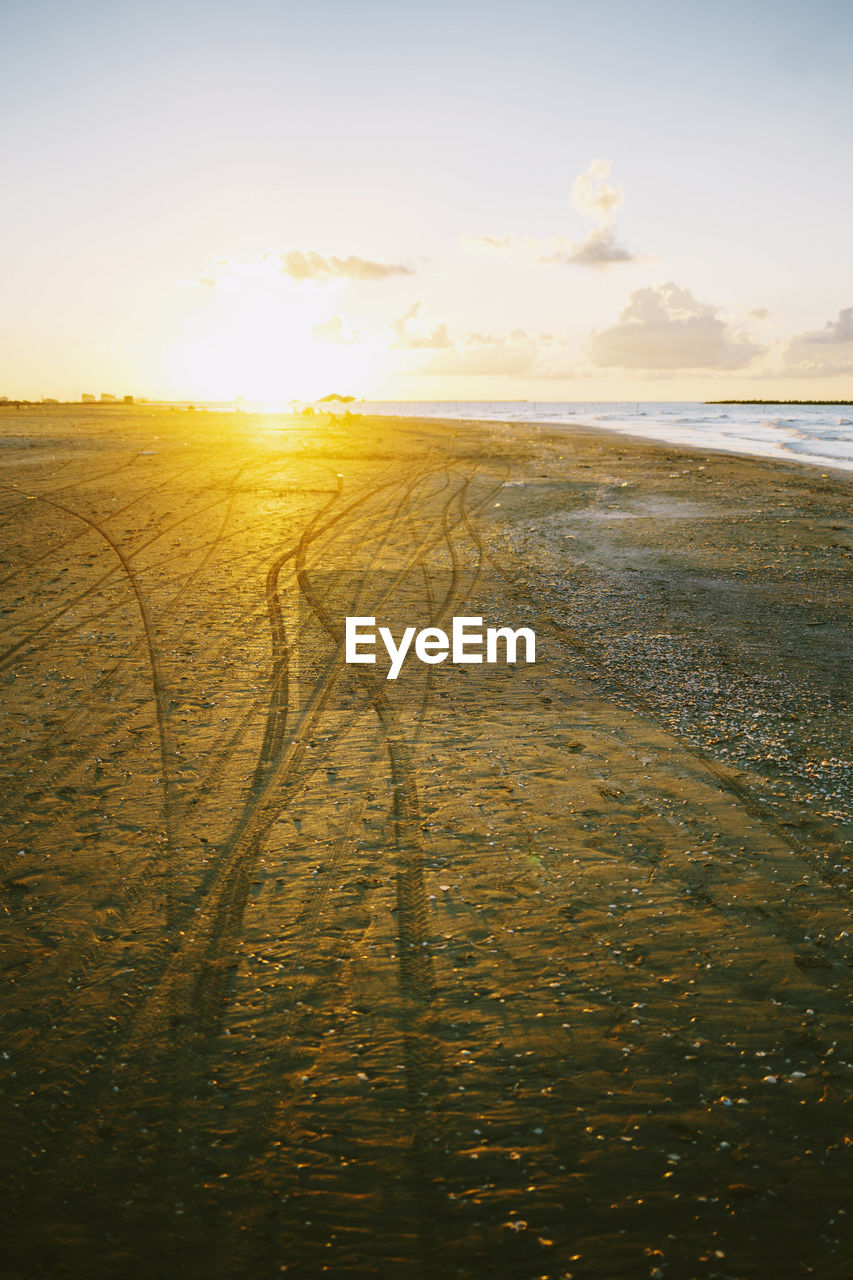 Scenic view of beach against sky during sunset