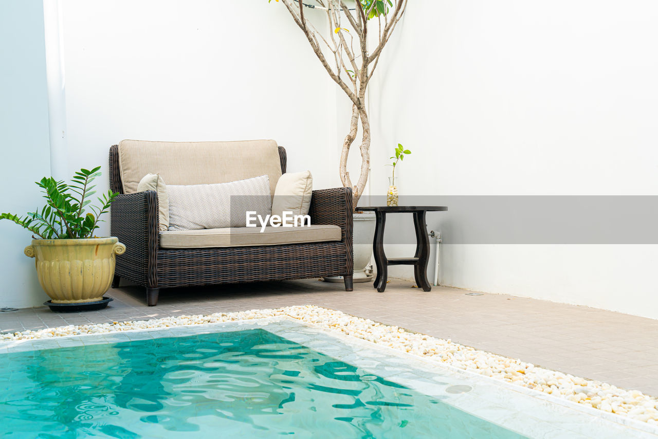 EMPTY CHAIRS AND TABLES IN ROOM